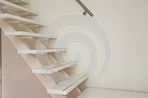 White modern wooden Staircase and white wall close-up