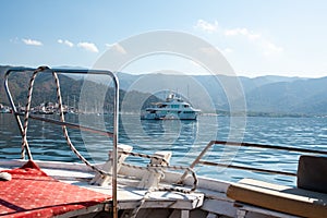 White modern yacht moored near Marmaris city in Turkey. Luxury white boat. Ships in the sea. Sea traveling. View from