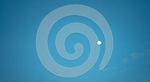 White moon against the blue sky