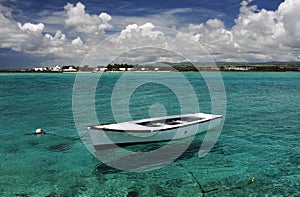 White moored boat and turquoise Indian Ocean, Mauritius.