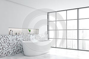 White mosaic bathroom corner with tub