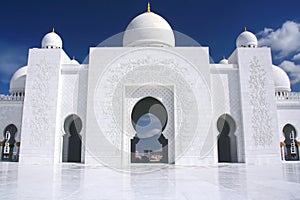 White mosque with cloudy blue sky