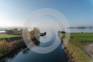 White motorboat approaches a river canal passing from one lake to another