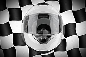 White motorcycle carbon integral crash helmet front of motorsport black and chequered flag background. car kart racing