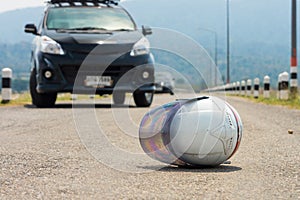 White motorcycle helmet and cars on road