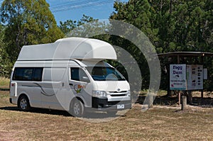 White motorhome, campervan vehicle parked at information sign at Fogg Dam