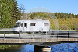 White Motorhome Traveling along Scenic Road