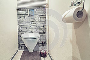 White mounted toilet bowl in modern bathroom