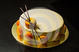 White mousse cake with macaron & chocolate deco