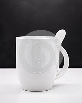 White mug on black backdrops. Blank coffee cup for your design