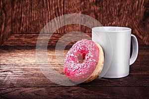 white mug and a donut on a wooden