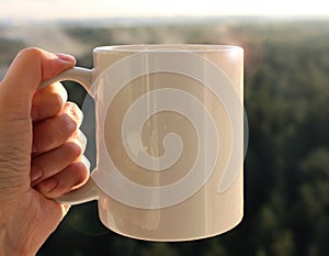 White mug in hand, Mockup