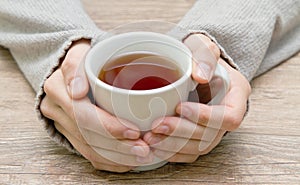 White mug in hands