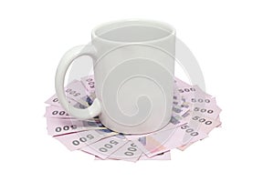 White mug over thai money isolated on white with clipping path