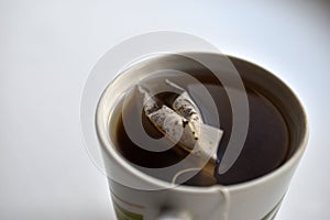 White mug with tea on a white background