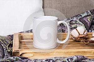 White mug on a wooden tray, the Mockup. Cozy home, linen and wool decorations