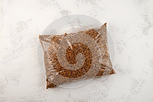 White mustard seeds in transparent plastic bag. Mustard seeds are an excellent site rate for enriching soil with organic matter.