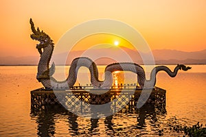 White Naga statue at Kwan Phayao with evening sun