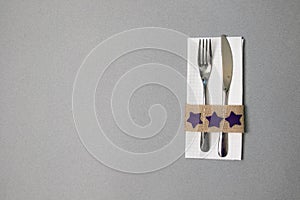 White napkin, knife and fork, place for dinner served in rustic