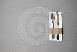 White napkin, knife and fork, place for dinner served in rustic