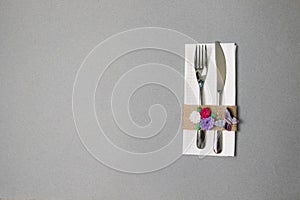 White napkin, knife and fork, place for dinner served in rustic