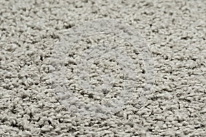 White natural fleece carpet texture background. Wool fabric texture fragment shaggy mat