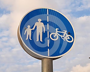 White and navy blue traffic sign for road walkers passangers and bicycle drivers showing the right lane to move on photo