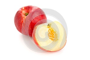 White nectarine whole and sliced over white