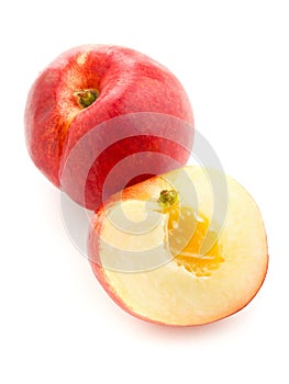 White nectarine whole and sliced over white