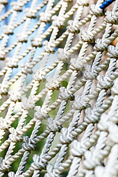 White net in the rope adventure park in the summer. Close up. Active sport life