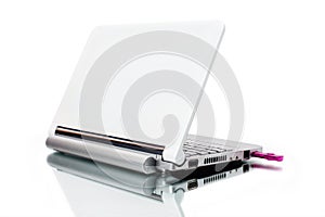 White netbook and pink USB key with reflected shadow