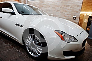 White new luxury sport car in detailing garage