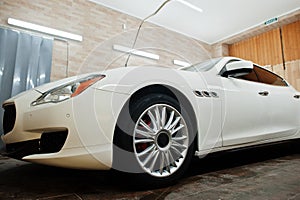 White new luxury sport car in detailing garage