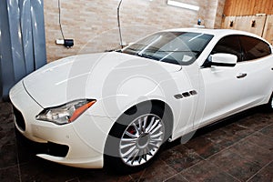 White new luxury sport car in detailing garage