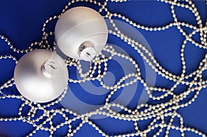 White New Year's toys on bright brilliant jewelry on a blue background