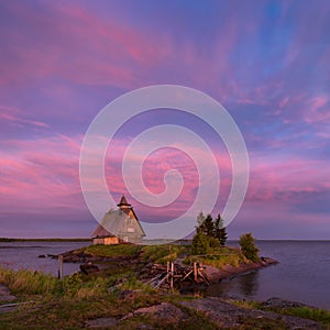 White Night On The White Sea Coast. Village Rabocheostrovsk, Republic Of Karelia. Old Russian Orthodox Wooden Church On Island