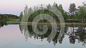 White nights on forest river in Karelia, Russia. Midnight. Calm water