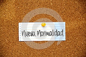 White note on cork board with message New normal