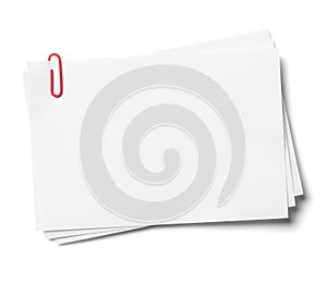 White note papers with red clip.