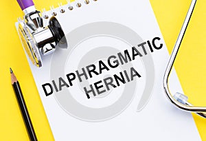 A white notepad with text Diaphragmatic hernia with stethoscope and black pencil on yellow background