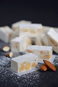 White nougat with almonds on ardesia plate