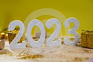 white numbers 2023 for the New Year holiday in December with glitter gold wooden cork