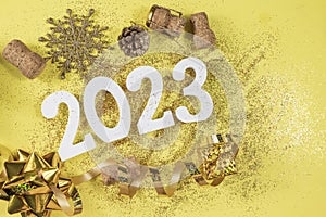 white numbers 2023 for the New Year holiday in December with glitter gold wooden cork