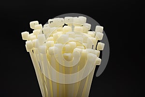 White nylon cable tie or zip tie on black background