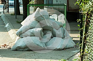 White nylon garbage bags on the street full of construction waste
