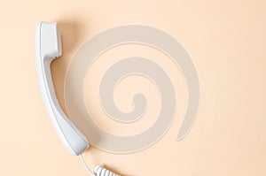 White office desk phone on yellow background