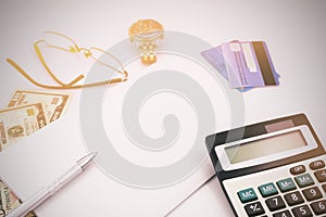 White office desk table with pen calculator glasses and banknote