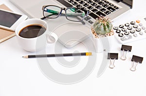 White office desk table, workspace office with laptop, smartphone black screen, coffee cup,pen,calculator, glasses, Top view with