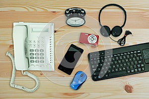 White office landline telephone and smartphone, Keyboard computer and table clock Used modern Electronic gadgets for daily use