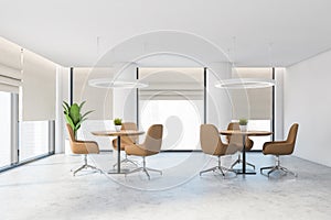 White office lounge area with beige chairs